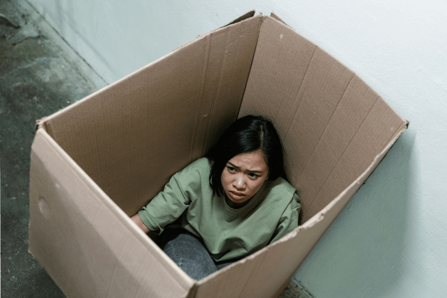a-fearful-woman-having-claustrophobia-in-a-cardboard-box