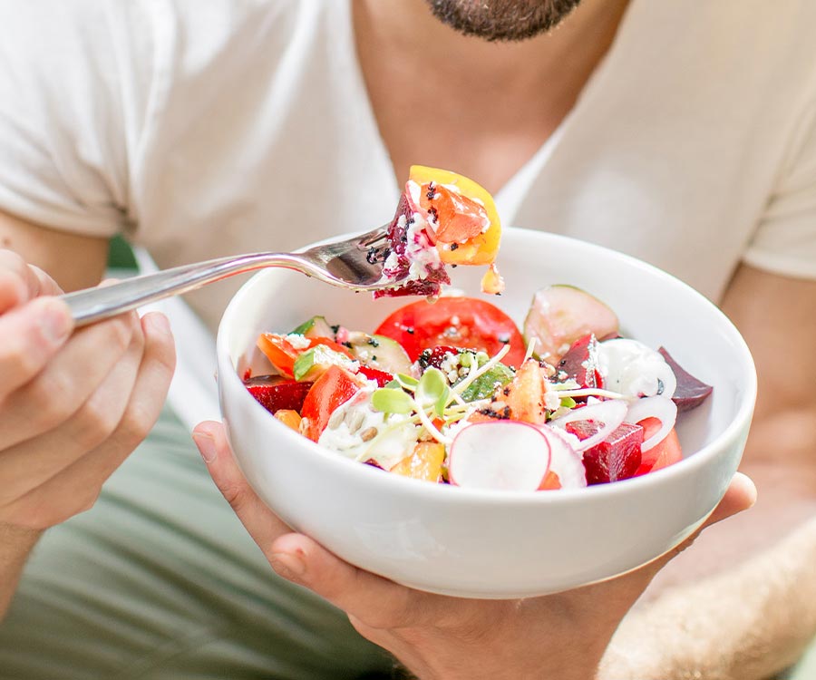 man-eating-salad-indoors