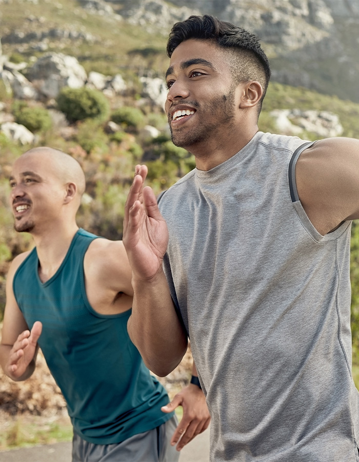shot-of-three-men-out-for-a-run-on-a-mountain-road